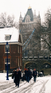 Guests and members of the branch walking through the snow with London Bridge in the background